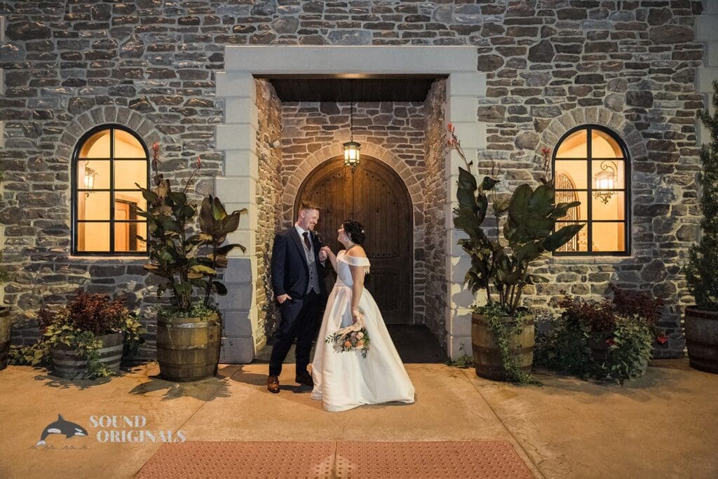 Couple hand in hand at the entryway of the villa at Folino Estate Winery