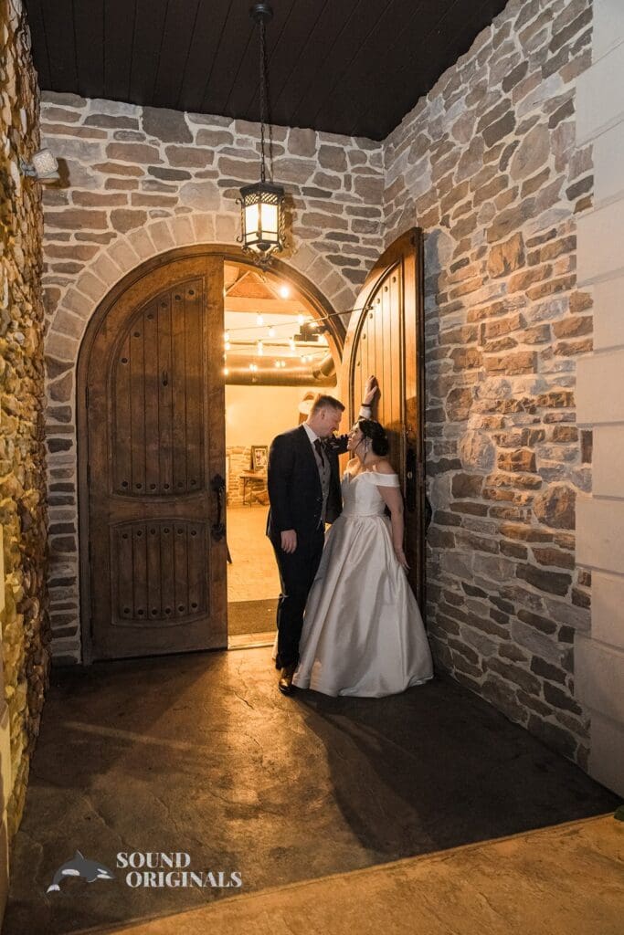 Couple sharing an intimate look while standing at the doorstep of the villa at Folino Estate Winery