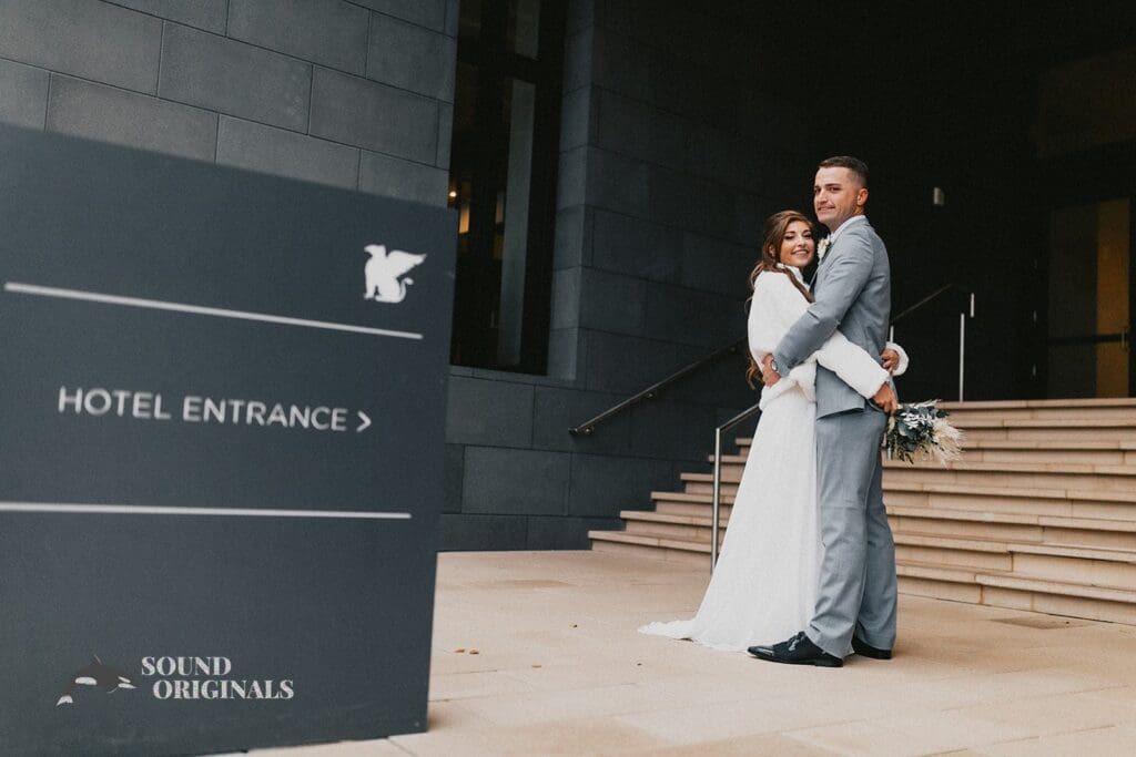 Nicole + Ryan Plant Park, Jackson's, Yeomans bride and groom take a romantic shot at the entrance of the building