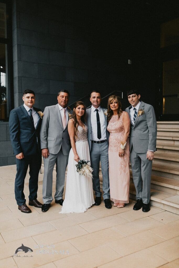 Nicole + Ryan Bride and groom take nice shot with bride's parents and old-school mates in Plant Park, Jackson's, Yeomans Wedding