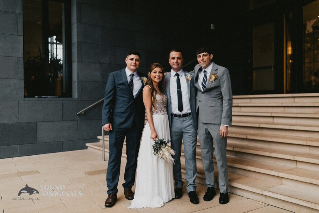 Nicole + Ryan Bride and groom take a clean shot in front of Plant Park, Jackson's, Yeomans with old-school mates