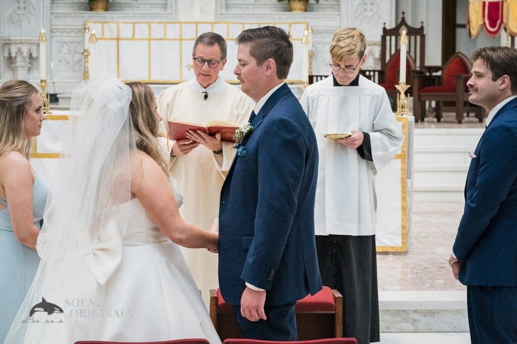 Happy couple exchange vows at their Cathedral Basilica of the Immaculate Conception Wedding
