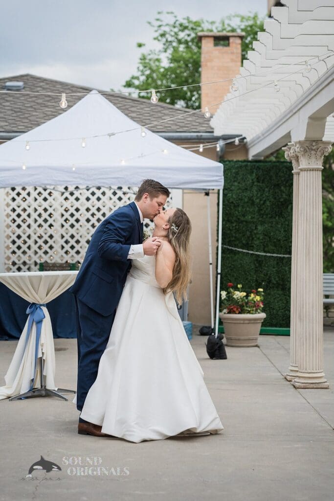 Wedding photographer captures kiss between husband and wife after Cathedral Basilica of the Immaculate Conception Wedding