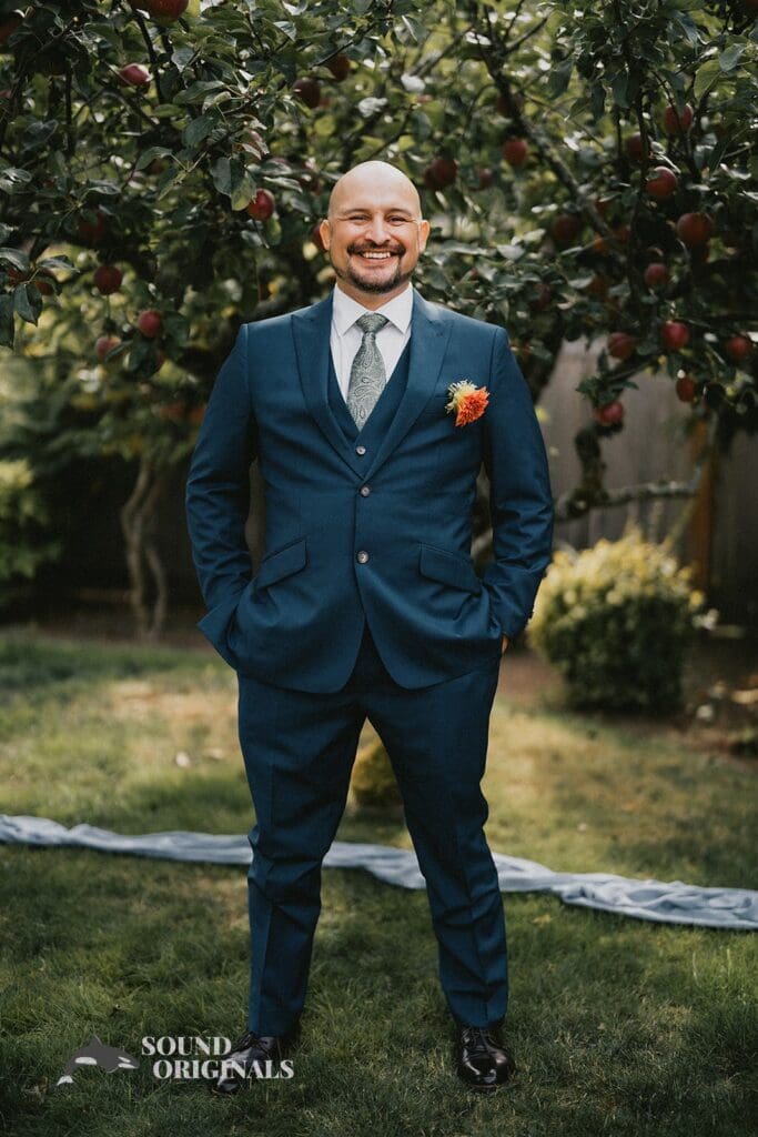 Kiara + Paul Husband stands elegantly at The Carey Gardens