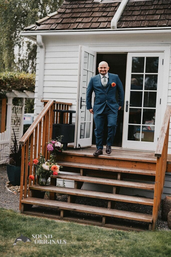 Kiara + Paul Husband walks down the stairs of The Carey Gardens