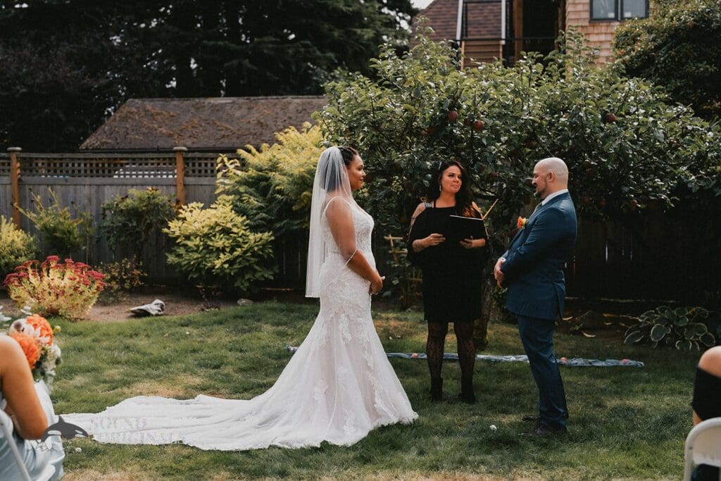 Kiara + Paul Bride and groom exchange marital vows at The Carey Gardens