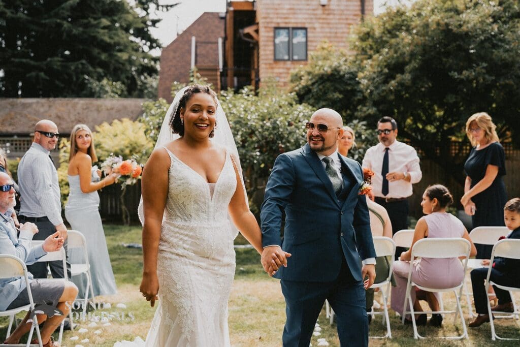 Kiara + Paul Husband and wife beam with joy over a successful exchange of vows at The Carey Gardens