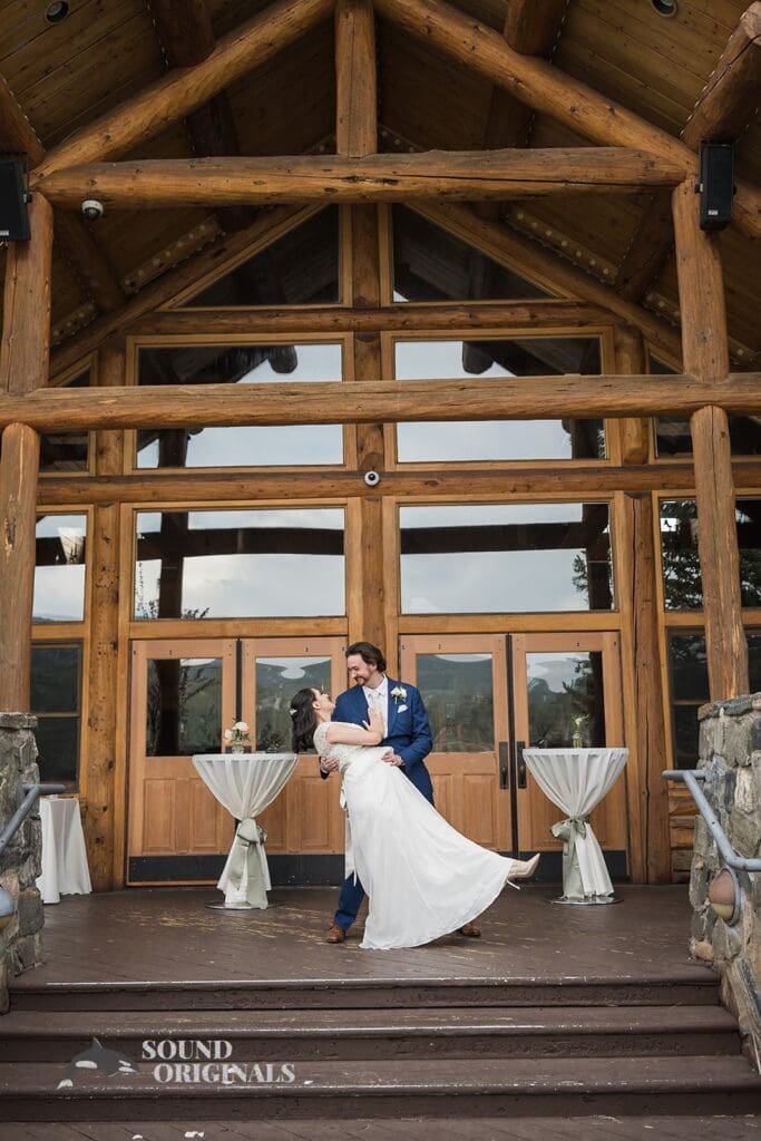 Evergreen Lake House Wedding bride and groom take a romantic shot in front of gigantic Evergreen Lake House