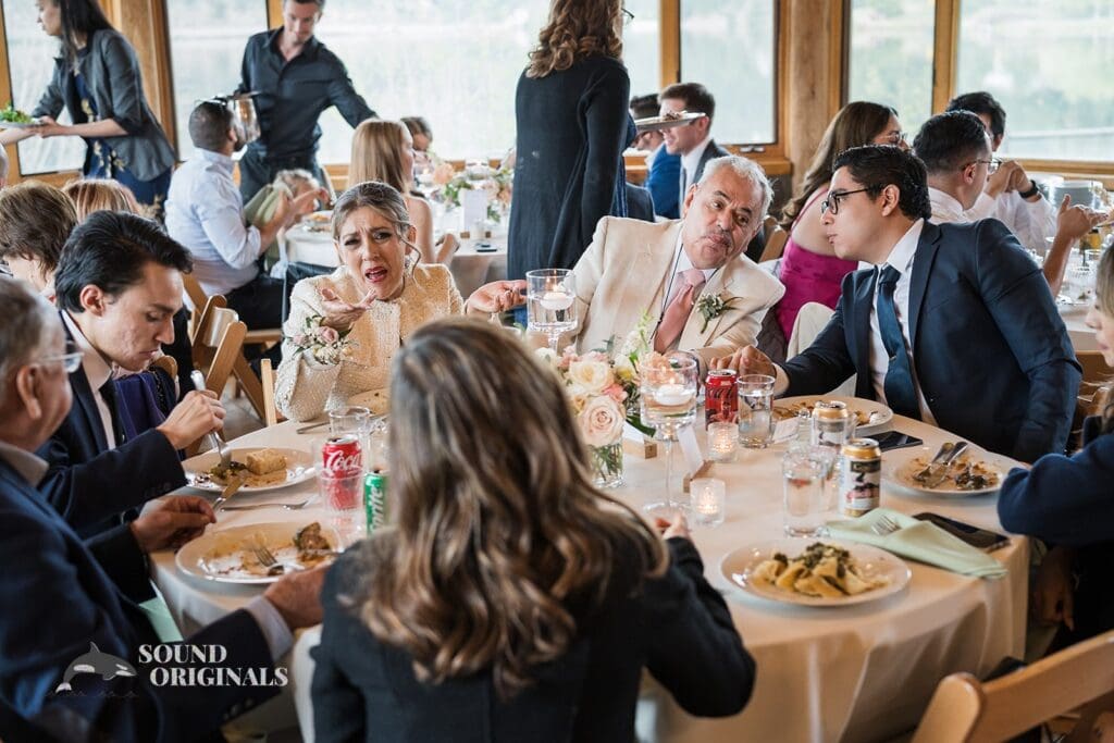Photographer captures bride's family enjoying the sumptuous delicacies served in Evergreen Lake House Wedding