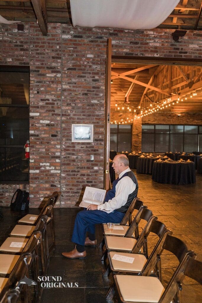 Wedding priest sits in Historic 1625 Tacoma Place Wedding