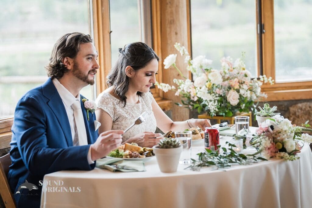 Bride and groom enjoy their meal in Evergreen Lake House Wedding