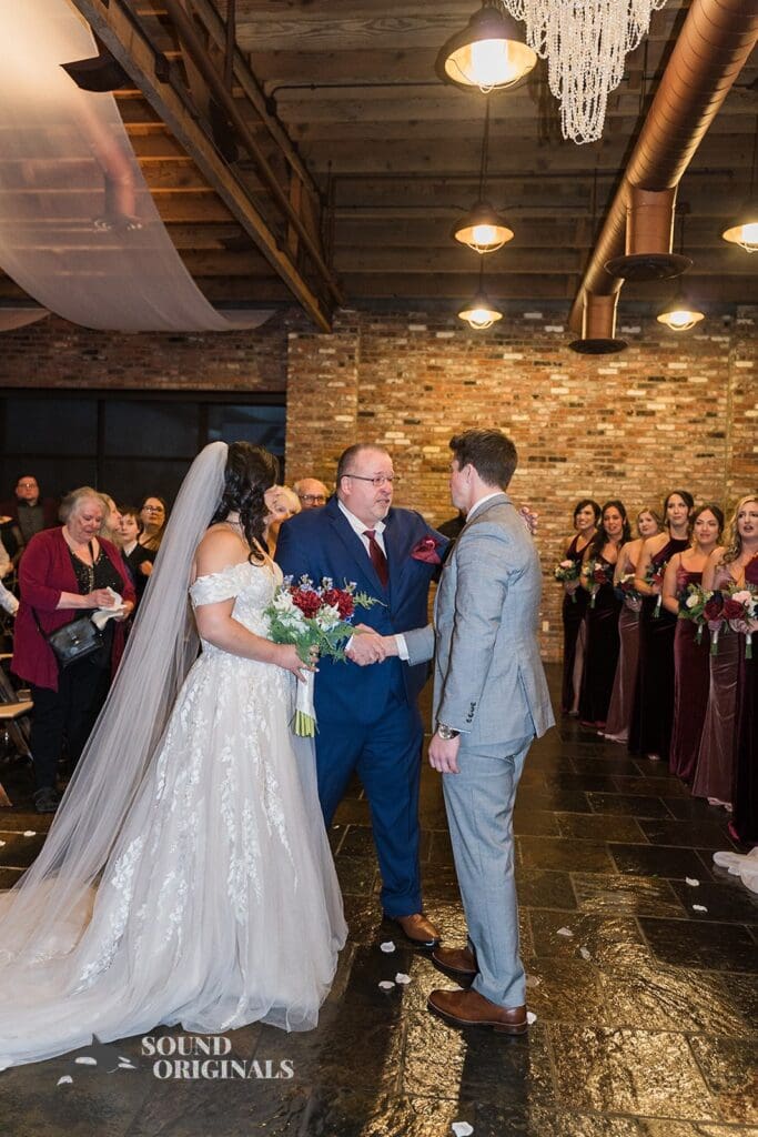 Bride's father handing bride over to groom at the Historic 1625 Tacoma Place Wedding altar
