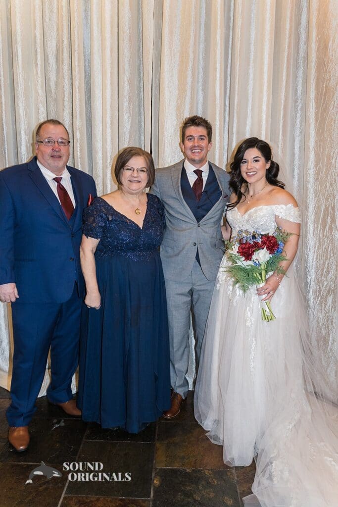 Bride, groom with bride's parents looking pretty at Historic 1625 Tacoma Place Wedding altar