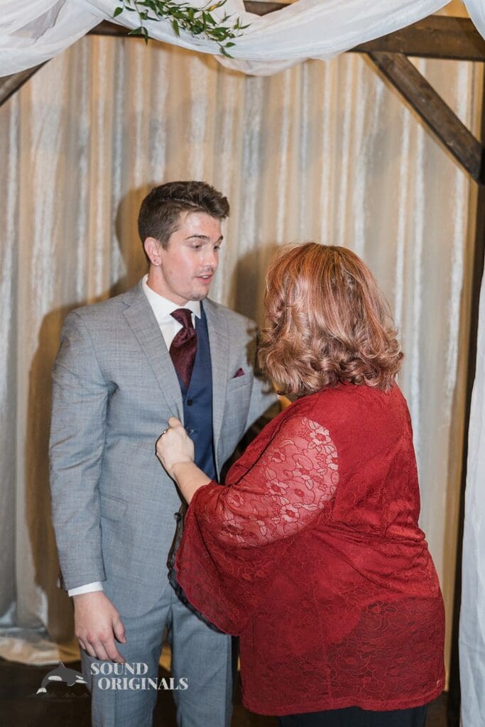 Groom's mum gets him ready at Historic 1625 Tacoma Place Wedding
