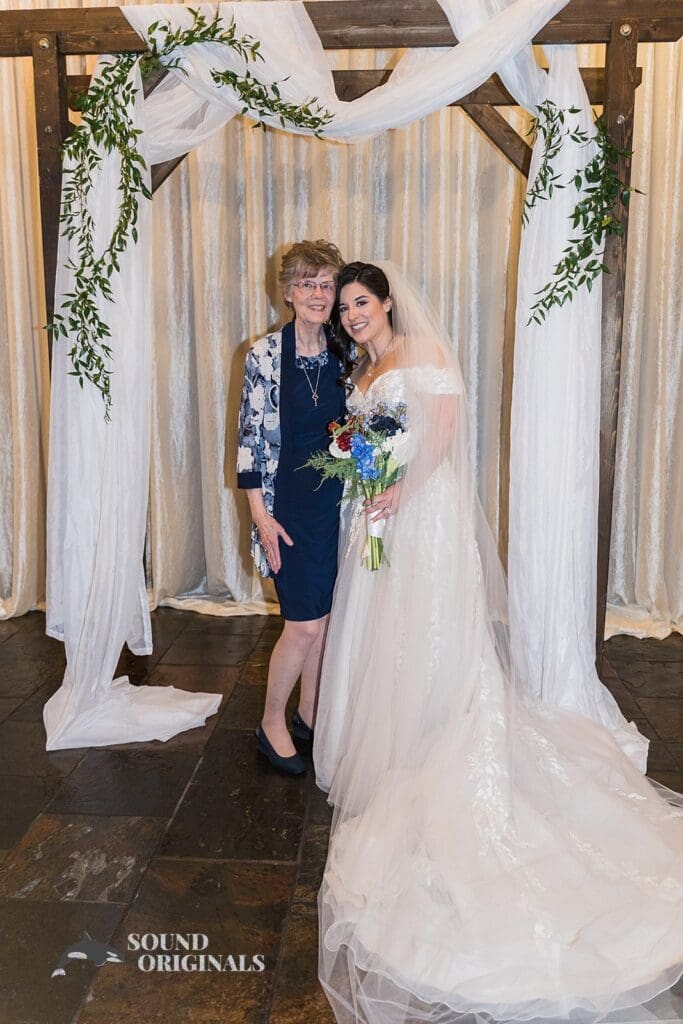 Beautiful bride and friend looking pretty in front of the Historic 1625 Tacoma Place Wedding altar
