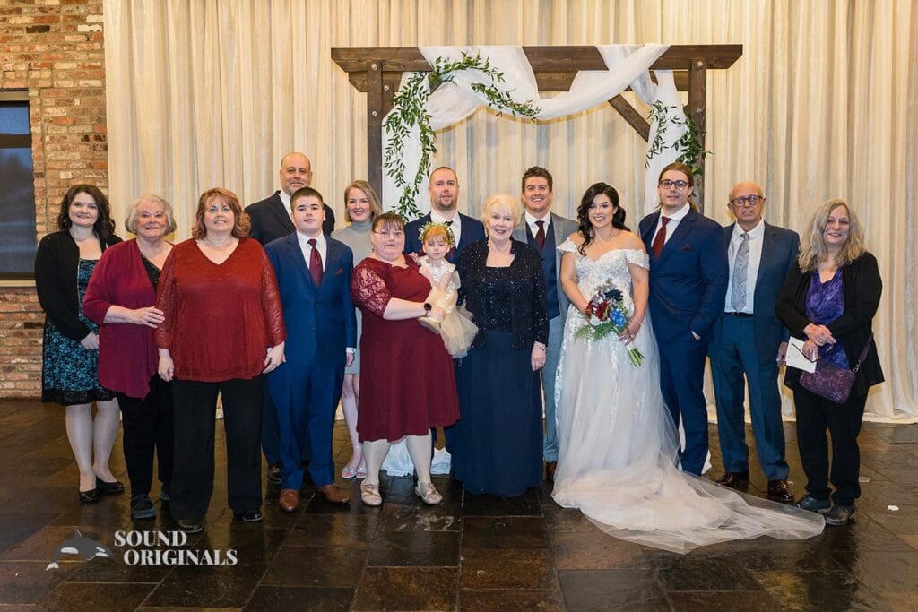 Bride and groom take beautiful picture with family and friends in the Historic 1625 Tacoma Place Wedding