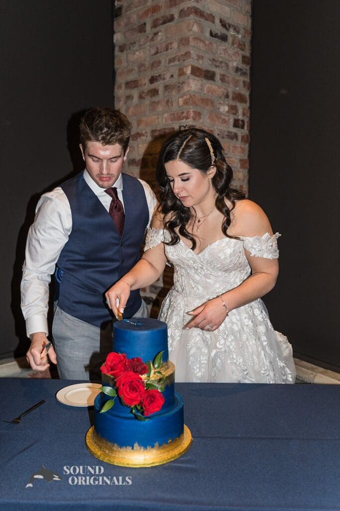 Pretty bride and groom getting ready to cut the wedding cake in the Historic 1625 Tacoma Place Wedding