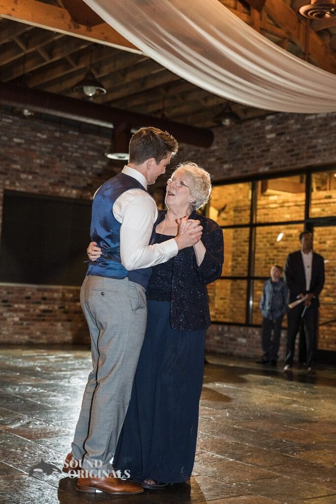 Groom and bride's mother ready to show off gentle dance steps in the Historic 1625 Tacoma Place Wedding