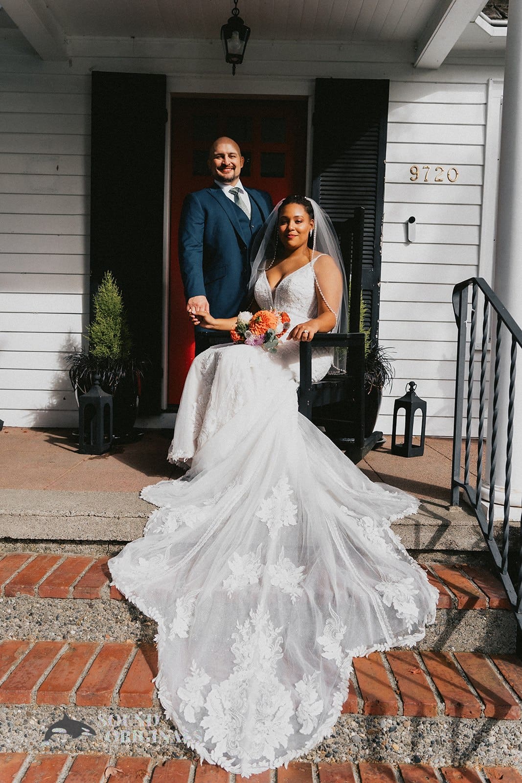 Bride and groom looking stunning in front of The Carey Gardens lodge