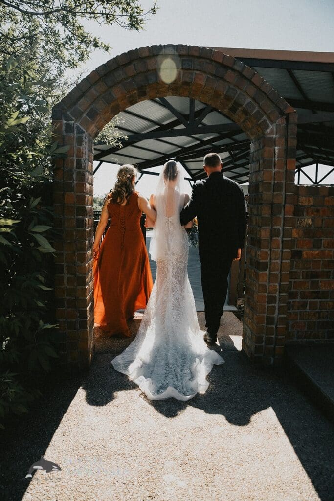 Wedding photographer captures entrance of the bride photo at Stoney Ridge Villa Wedding