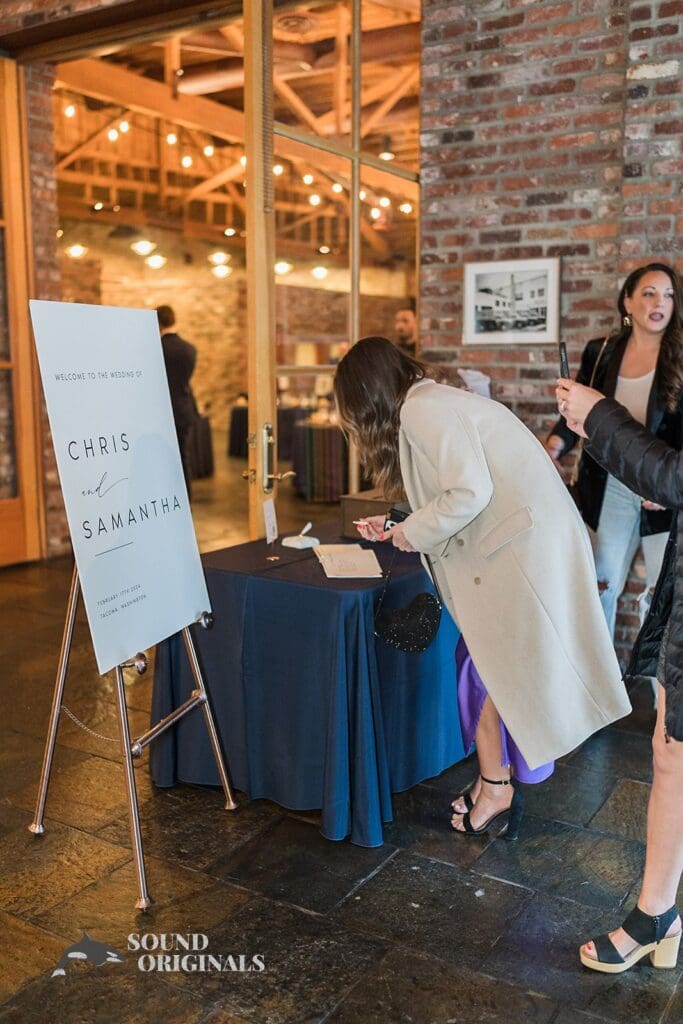 Guest enterering her name in front of the Historic 1625 Tacoma Place Wedding reception hall