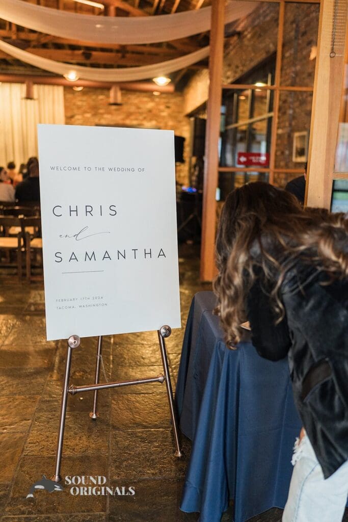Wedding welcome card stands elegantly at Historic 1625 Tacoma Place Wedding