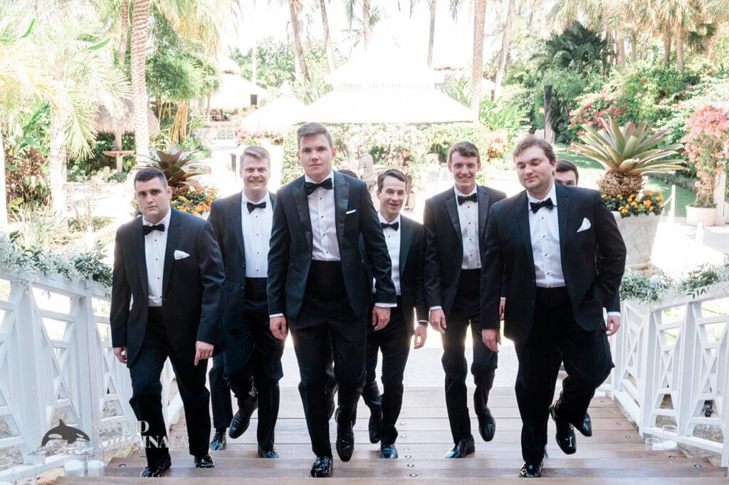 Action shot of the groom and his groomsmen walking to the venue at The Palms Hotel & Spa Wedding
