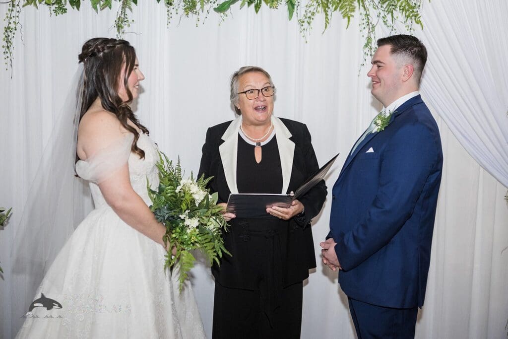 Priest about to wed bride and groom at Willows Heights Mansion altar