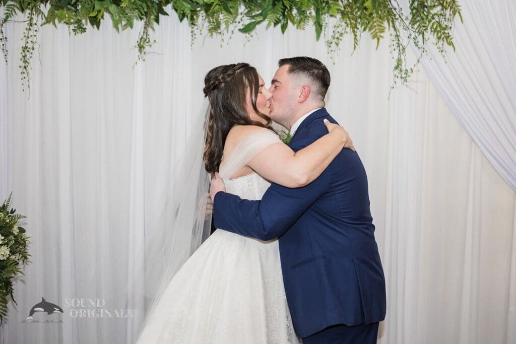 Bride and groom seals the marital vows at Willow Heights Mansion altar