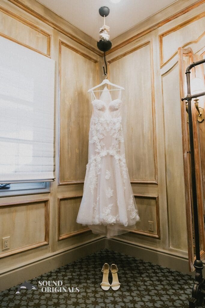 Beautiful wedding dress and shoes hung at The Havens Country Club suite