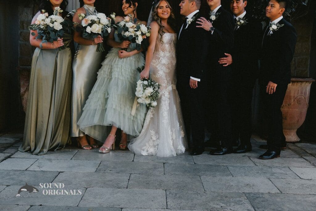Husband and wife in a clean shot with bridal train and groom's men in The Havens Country Club Wedding