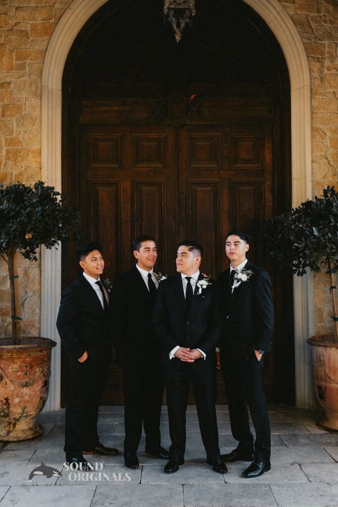 Photographer captures Handsome groom with groom's men in front of The Havens Country Club building