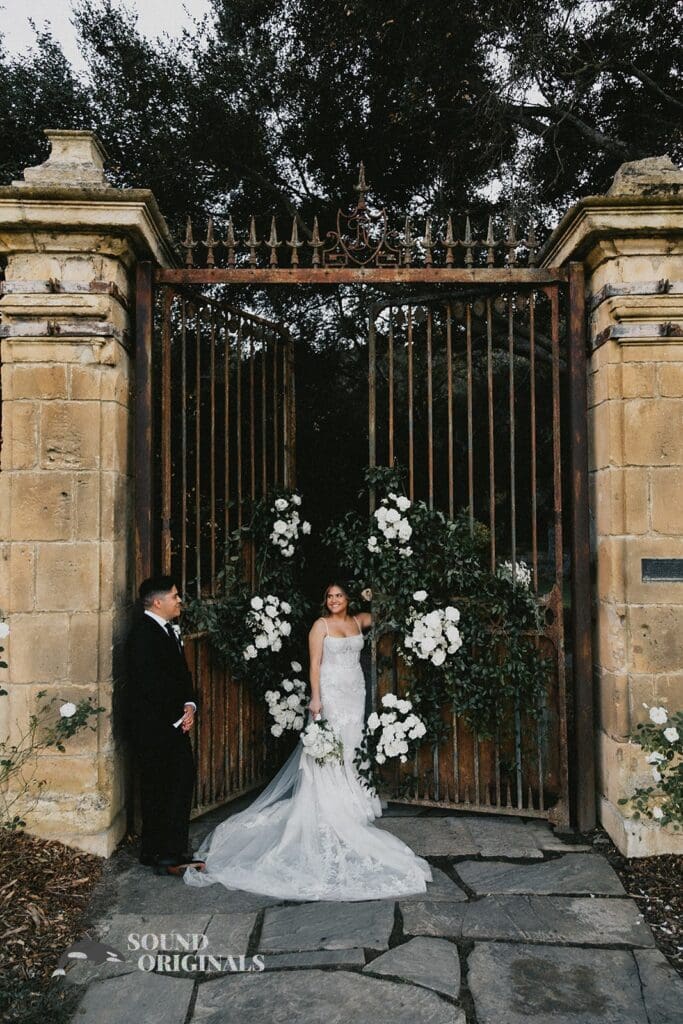 Gorgeous husband and wife take a romantic shot in front of The Havens Country Club