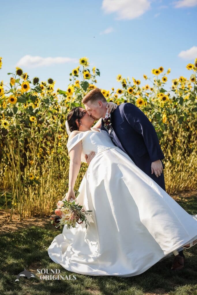 Couple kissing at the middle of the sunflower field at Folino Estate Winery