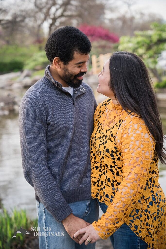 couple holding hands and staring at eacher at Osaka Garden