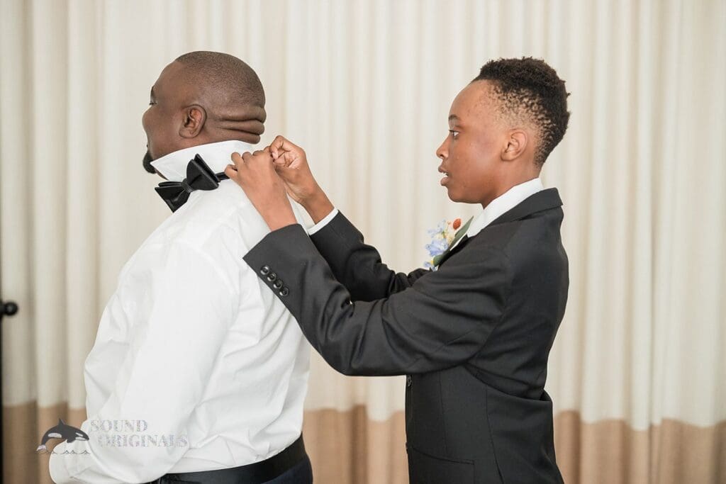 Groom's boy gets groom prepared for The Cliff House Dallas Wedding