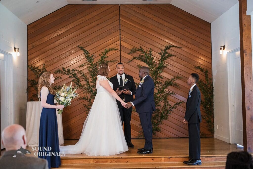 Bride and groom exchange marital at The Cliff House Dallas Wedding altar