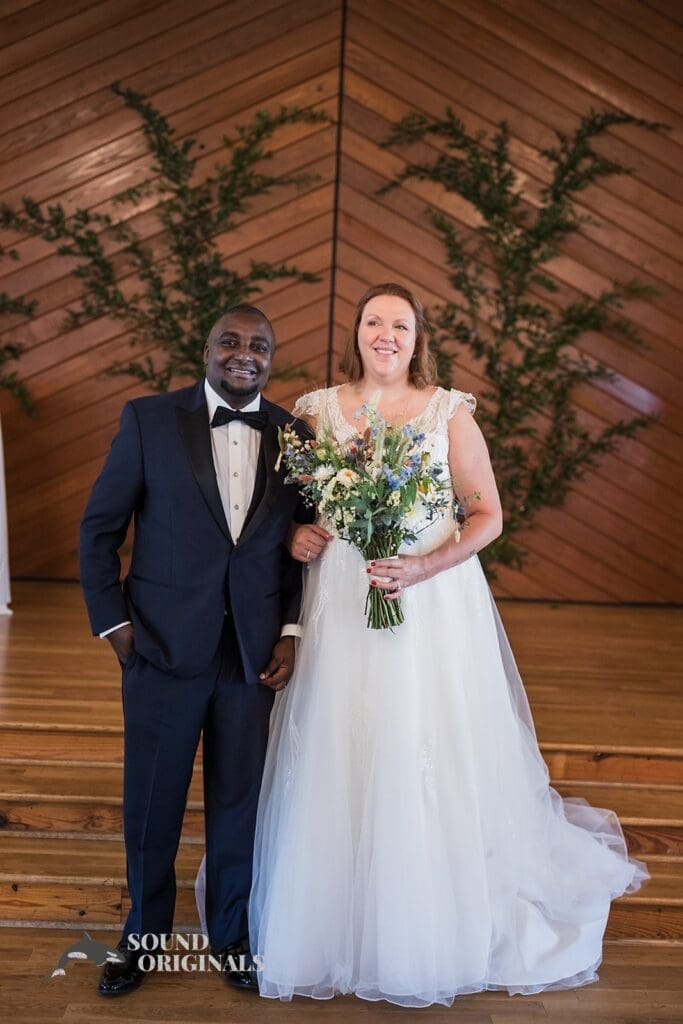 Bride and groom pose for a nice shot in front of The Cliff House Dallas Wedding altar