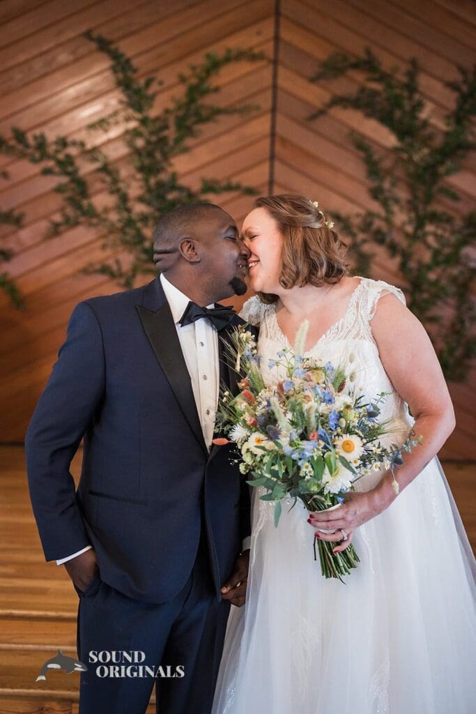Pretty bride and groom seal their marital vows with a charming kiss in The Cliff House Dallas Wedding