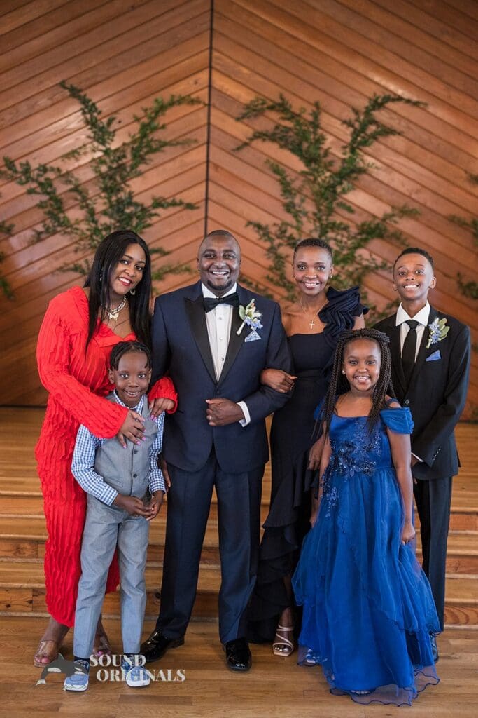Groom takes a beautiful shot with family in The Cliff House Dallas Wedding