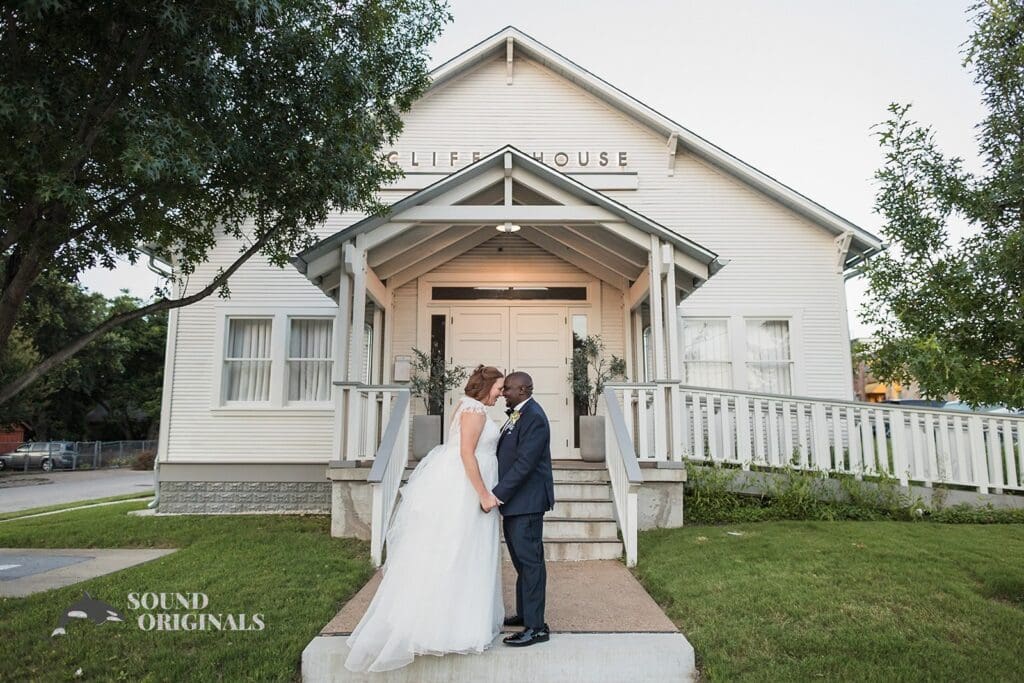 Bride and groom about to kiss in front of the gorgeous Cliff House