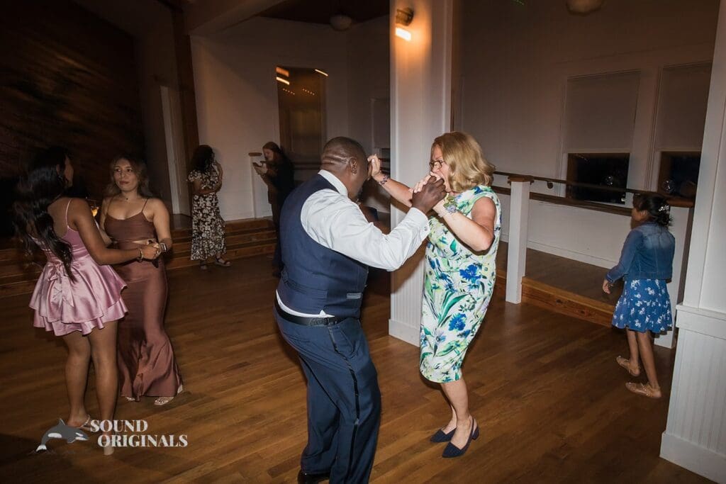 Energetic groom and bride's mum show off nice dance steps in The Cliff House Dallas Wedding reception