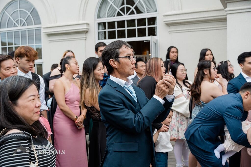 Wedding guests watching the couple make their vows at The Abbington Distinctive Banquets Wedding