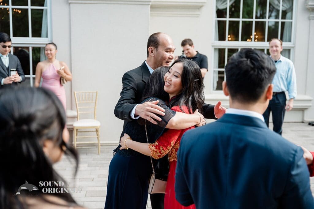 Bride sharing a hug with guests at The Abbington Distinctive Banquets Wedding