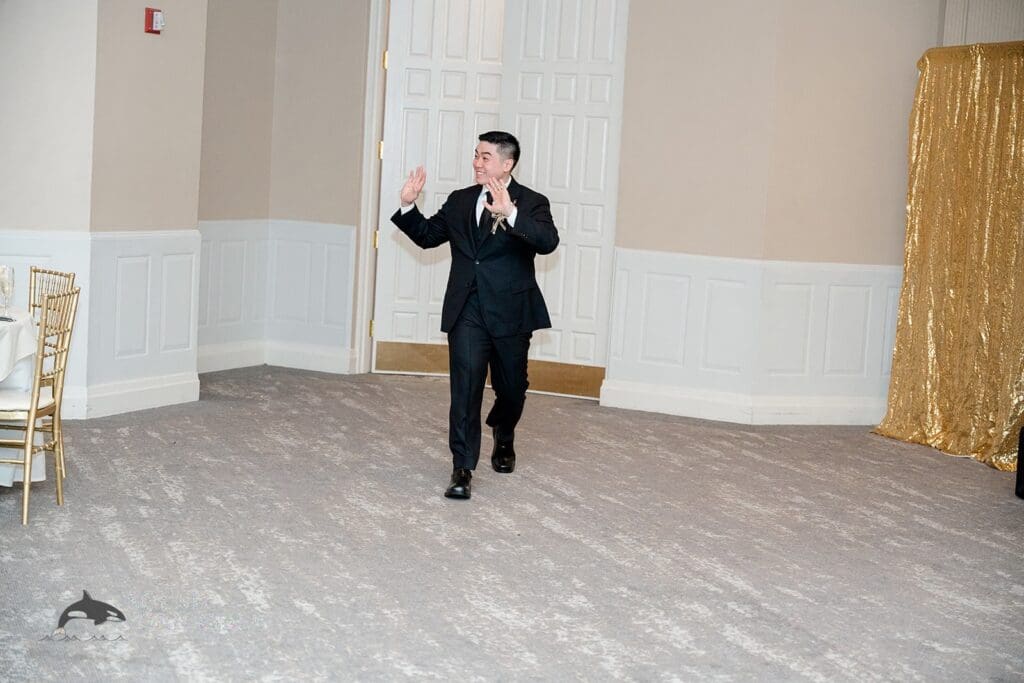 The groom entering The Abbington Distinctive Banquets Wedding reception