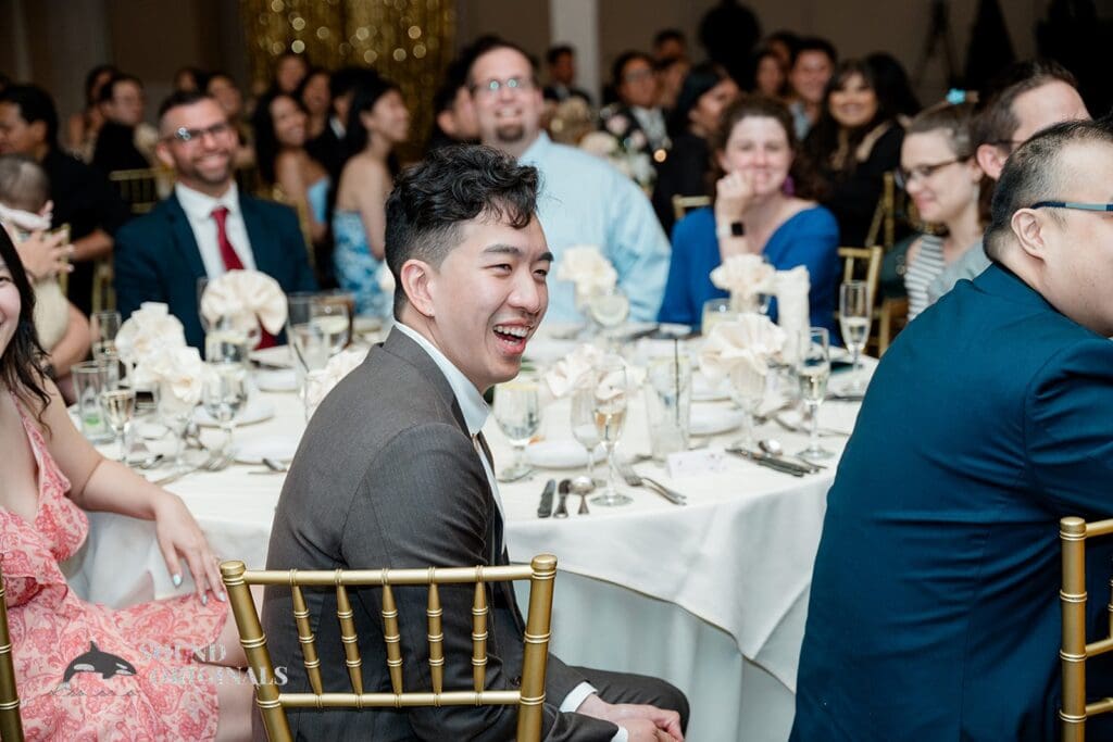 Guests laughing during the speeches at The Abbington Distinctive Banquets Wedding