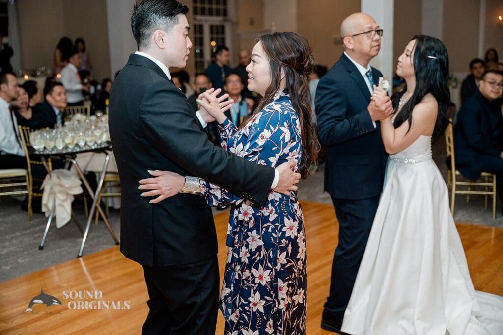 Bride and groom dancing with guests at The Abbington Distinctive Banquets Wedding