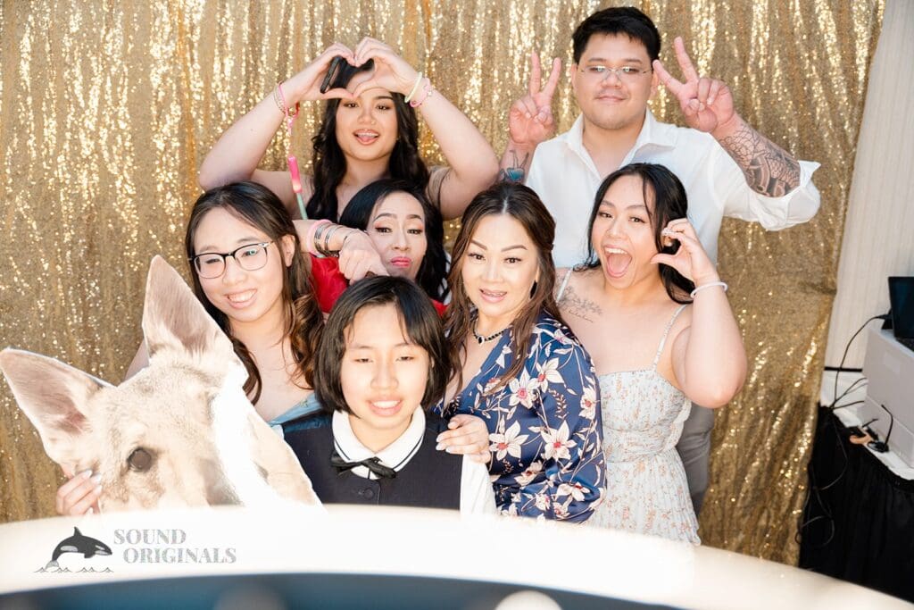 Guests taking photos in the photo booth at The Abbington Distinctive Banquets Wedding