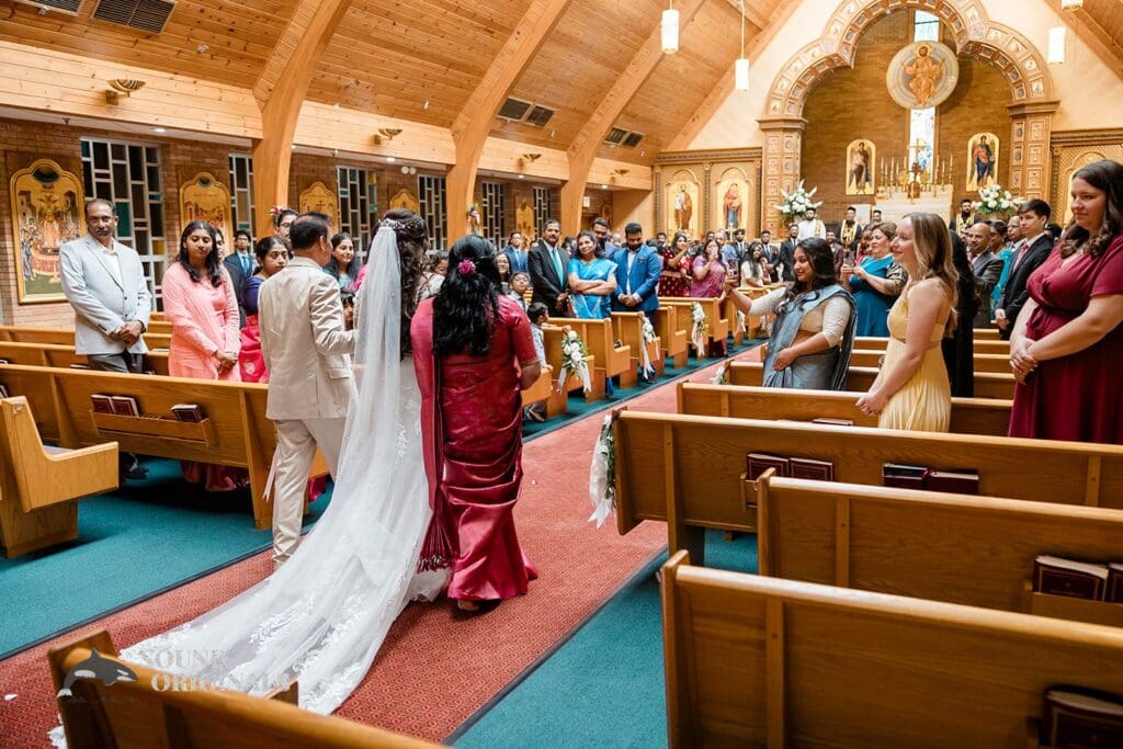 The bride walking down the aisle at the Embassy Suites by Hilton Naperville Wedding