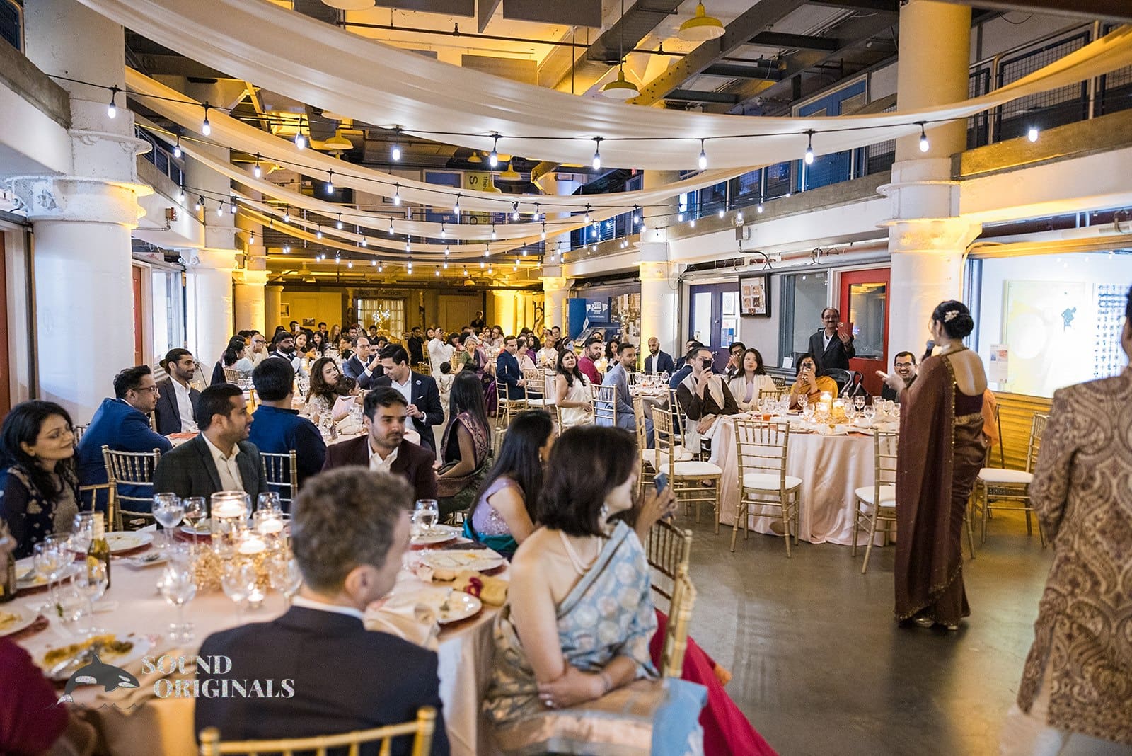 Wedding guests listening to the bride at Torpedo Factory Art Center Wedding